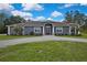 Attractive single-story home with a circular driveway and stone accents enhancing curb appeal at 27338 Elkwood Cir, Wesley Chapel, FL 33544