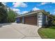 Spacious three-car garage and a concrete driveway at 27338 Elkwood Cir, Wesley Chapel, FL 33544