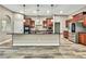 Modern kitchen features wood cabinets, stainless steel appliances, and a spacious island with black countertop at 27338 Elkwood Cir, Wesley Chapel, FL 33544