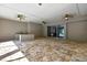 Lanai featuring stone floors, ceiling fans, outdoor kitchen and sliding doors to interior spaces at 27338 Elkwood Cir, Wesley Chapel, FL 33544