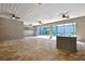 Spacious lanai with stone floors, ceiling fans, and bar area overlooking the pool at 27338 Elkwood Cir, Wesley Chapel, FL 33544