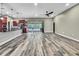 Open layout with wood-look floors, a modern kitchen, and sliding glass doors, blending indoor and outdoor living beautifully at 27338 Elkwood Cir, Wesley Chapel, FL 33544