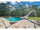 Screened pool with a slide, waterfall feature, and ample space for entertaining at 27338 Elkwood Cir, Wesley Chapel, FL 33544