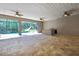 Lanai featuring stone floors, ceiling fans, outdoor kitchen and view of screened pool and slide at 27338 Elkwood Cir, Wesley Chapel, FL 33544