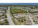 Aerial view of neighborhood with a mix of modern homes with lush greenery and access to lakes and community amenities at 2747 Wood Pointe Dr, Holiday, FL 34691