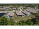 Backyard view of homes in a residential area, with lush green lawn and shrubs at 2747 Wood Pointe Dr, Holiday, FL 34691