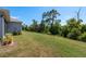Expansive backyard with lush lawn and mature trees, providing privacy and tranquility at 2747 Wood Pointe Dr, Holiday, FL 34691