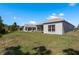 The property boasts a large grassy area with mature trees at 2747 Wood Pointe Dr, Holiday, FL 34691