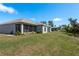 Spacious backyard featuring a screened lanai and well-maintained landscaping at 2747 Wood Pointe Dr, Holiday, FL 34691