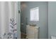 Cozy bathroom featuring white cabinet, functional grab bar, and soft, neutral color palette at 2747 Wood Pointe Dr, Holiday, FL 34691