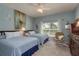 Cozy bedroom featuring two beds, soft lighting, and a peaceful ambiance at 2747 Wood Pointe Dr, Holiday, FL 34691