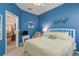 Charming bedroom with blue walls, white furniture, and lots of natural light at 2747 Wood Pointe Dr, Holiday, FL 34691