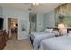 Light blue bedroom showcases two twin beds, ceiling fan, soft carpet, and art at 2747 Wood Pointe Dr, Holiday, FL 34691