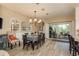 Bright dining area with a modern chandelier and sliding doors to the patio at 2747 Wood Pointe Dr, Holiday, FL 34691