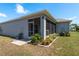 The home features a screened lanai, manicured landscaping, and a lush lawn at 2747 Wood Pointe Dr, Holiday, FL 34691