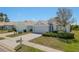 Well maintained homes with manicured lawns and sidewalks under a sunny sky at 2747 Wood Pointe Dr, Holiday, FL 34691