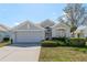 Charming single-story home featuring a well-manicured lawn and attached two-car garage at 2747 Wood Pointe Dr, Holiday, FL 34691