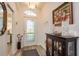 Inviting front foyer with decorative glass door, wood floors, and elegant furnishings at 2747 Wood Pointe Dr, Holiday, FL 34691