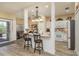 Bright kitchen with stainless steel appliances, breakfast bar with seating, and access to an outdoor patio at 2747 Wood Pointe Dr, Holiday, FL 34691