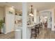 Bright kitchen with white cabinets, breakfast bar with seating, and modern fixtures at 2747 Wood Pointe Dr, Holiday, FL 34691