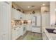 Well-equipped kitchen featuring white cabinetry, modern appliances, and sleek countertops at 2747 Wood Pointe Dr, Holiday, FL 34691