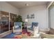 Comfortable lanai featuring cozy seating, decorative art, and a seamless transition to the outdoors at 2747 Wood Pointe Dr, Holiday, FL 34691