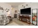 Well-decorated living room with a large television and a cozy fireplace at 2747 Wood Pointe Dr, Holiday, FL 34691