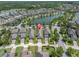 Bird's eye view of the home with nearby lake and mature trees at 3095 Riders Pass, Odessa, FL 33556