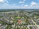 Wide aerial view of the community with lake and surrounding greenery at 3095 Riders Pass, Odessa, FL 33556