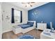 Bedroom featuring themed decor, ample natural light, and wood-look floors at 3095 Riders Pass, Odessa, FL 33556
