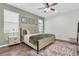 Comfortable bedroom featuring a bed with decorative pillows, a nightstand, and stylish wall art for a cozy feel at 3095 Riders Pass, Odessa, FL 33556