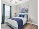 Tranquil bedroom featuring a cozy bed, blue accents, stylish curtains, and ample natural light at 3095 Riders Pass, Odessa, FL 33556