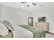 Bedroom with a comfortable bed, modern dresser with TV, and ample natural light from a window at 3095 Riders Pass, Odessa, FL 33556