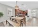 An open dining area features a wooden table with bench seating, connected to the kitchen with stainless steel appliances at 3095 Riders Pass, Odessa, FL 33556