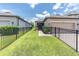 Charming single-story home with well-manicured lawn and dark metal fence at 3095 Riders Pass, Odessa, FL 33556