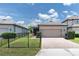 Well-maintained home with a two-car garage, landscaped yard, and a brick driveway at 3095 Riders Pass, Odessa, FL 33556