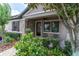 Close-up of the welcoming front porch with seating and lush landscaping at 3095 Riders Pass, Odessa, FL 33556