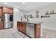 Open-concept kitchen featuring a spacious island and stainless steel appliances at 3095 Riders Pass, Odessa, FL 33556