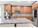 Elegant kitchen with stainless appliances, tiled backsplash, and a kitchen island at 3095 Riders Pass, Odessa, FL 33556