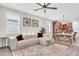 Bright and spacious living room featuring hardwood floors, a ceiling fan, and stylish decor at 3095 Riders Pass, Odessa, FL 33556