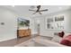 Well-lit living room with a decorative cabinet and a flat-screen television at 3095 Riders Pass, Odessa, FL 33556