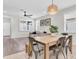 Bright living room featuring a stylish sofa, a decorative rug, and a dining area with a wooden table and chairs at 3095 Riders Pass, Odessa, FL 33556