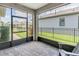 Screened patio featuring a brick floor, black frames, and an outdoor view at 3095 Riders Pass, Odessa, FL 33556