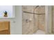 Modern shower featuring tile walls, a mosaic accent stripe, and a convenient corner shelf for toiletries at 3095 Riders Pass, Odessa, FL 33556