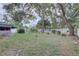 Expansive backyard with mature trees offering shade and privacy at 3104 W Powhatan Ave, Tampa, FL 33614