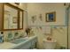 Quaint bathroom featuring tile accents, vanity, and framed wall art creates an inviting atmosphere at 3104 W Powhatan Ave, Tampa, FL 33614