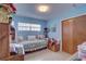 Inviting secondary bedroom with daybed and closet, creating a functional and personalized space at 3104 W Powhatan Ave, Tampa, FL 33614