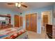 Bedroom view showcasing a closet, dresser, TV and access to an en-suite bathroom at 3104 W Powhatan Ave, Tampa, FL 33614