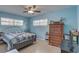 Bright bedroom with a decorative bed frame, classic wooden dresser, and plenty of natural light at 3104 W Powhatan Ave, Tampa, FL 33614