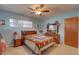 Comfortable bedroom with ceiling fan, window, and adjacent furnishings creates a relaxing personal space at 3104 W Powhatan Ave, Tampa, FL 33614